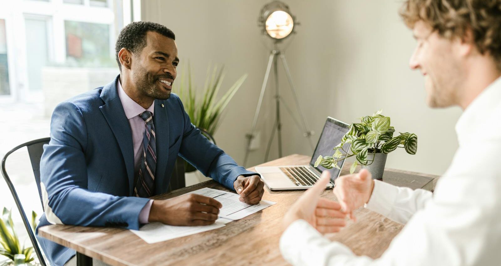 Men Sitting at Table Smiling